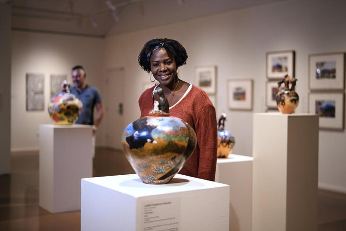 a woman standing next to a vase in a museum