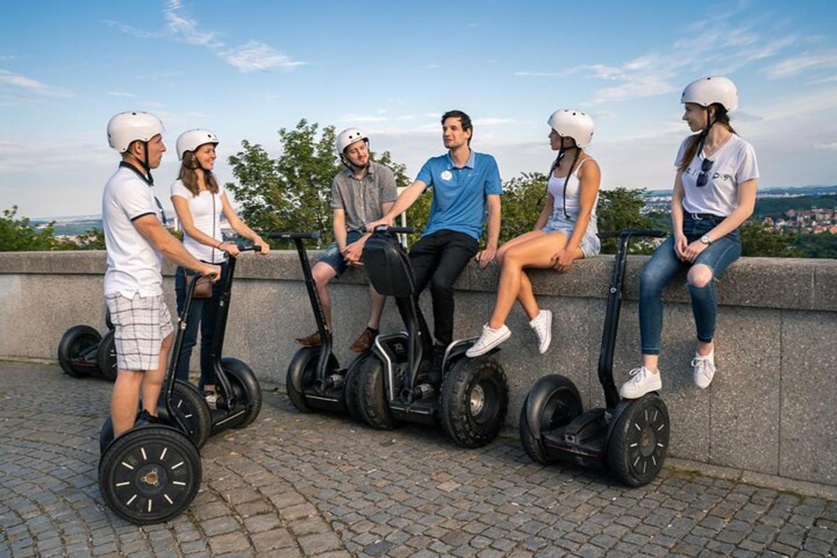 a group of people sitting on segways on a wall