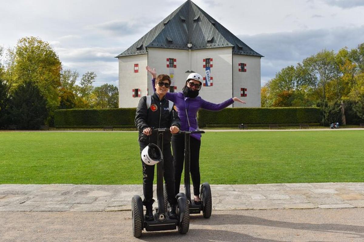 a man and a woman riding on segifts in front of a building
