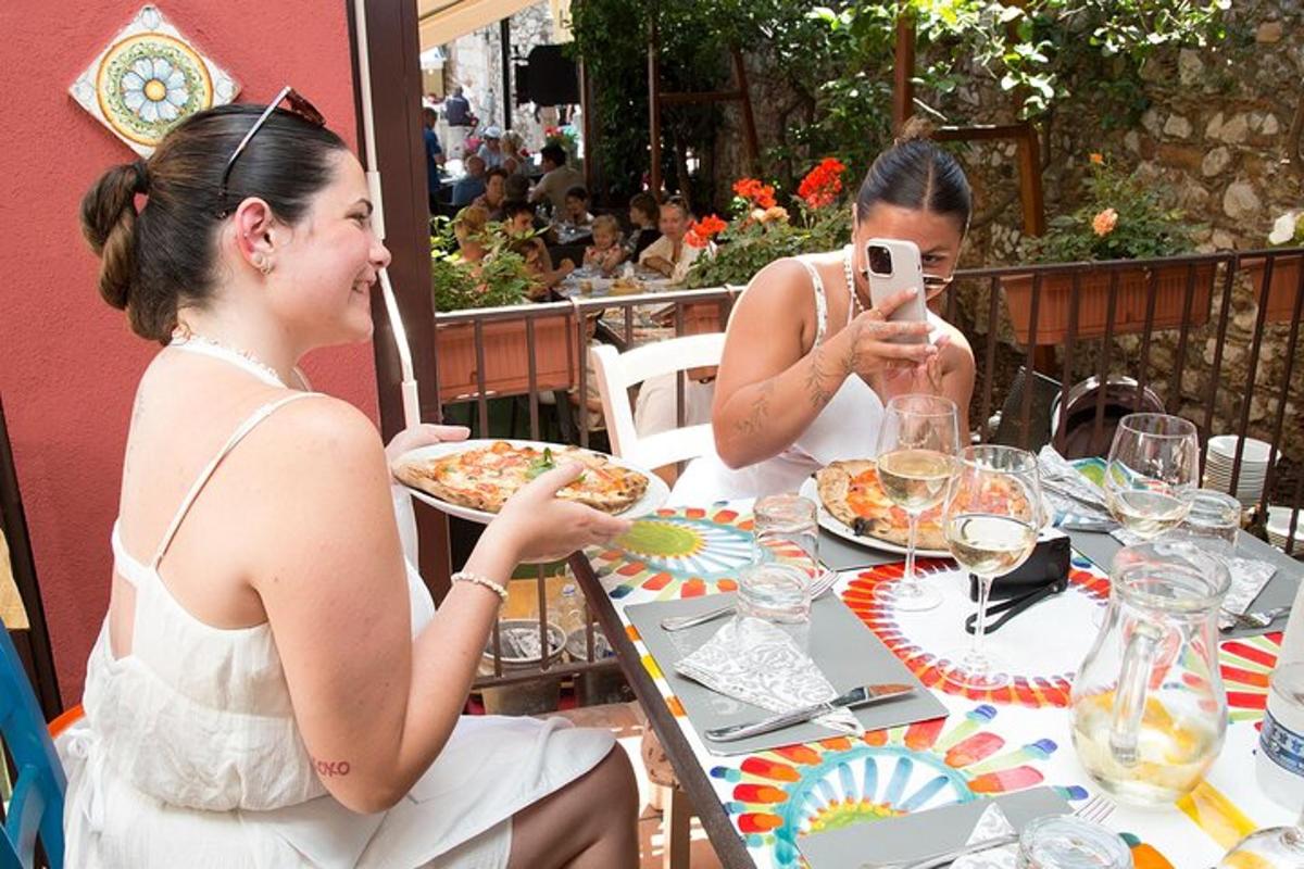 two women sitting at a table eating food