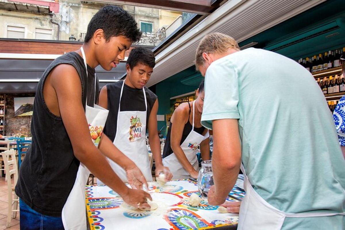 a group of people standing around a table with a cake