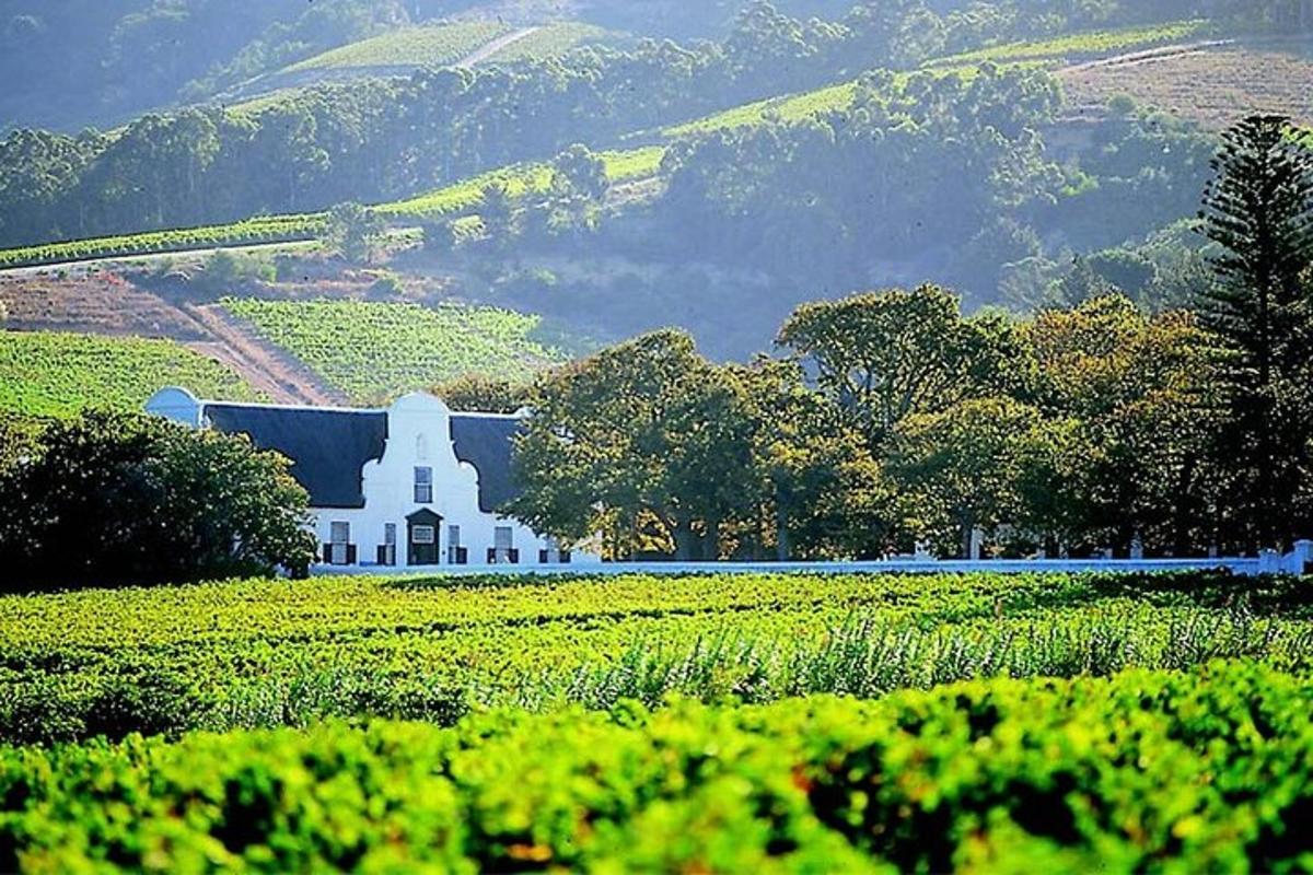 a white building in the middle of a field