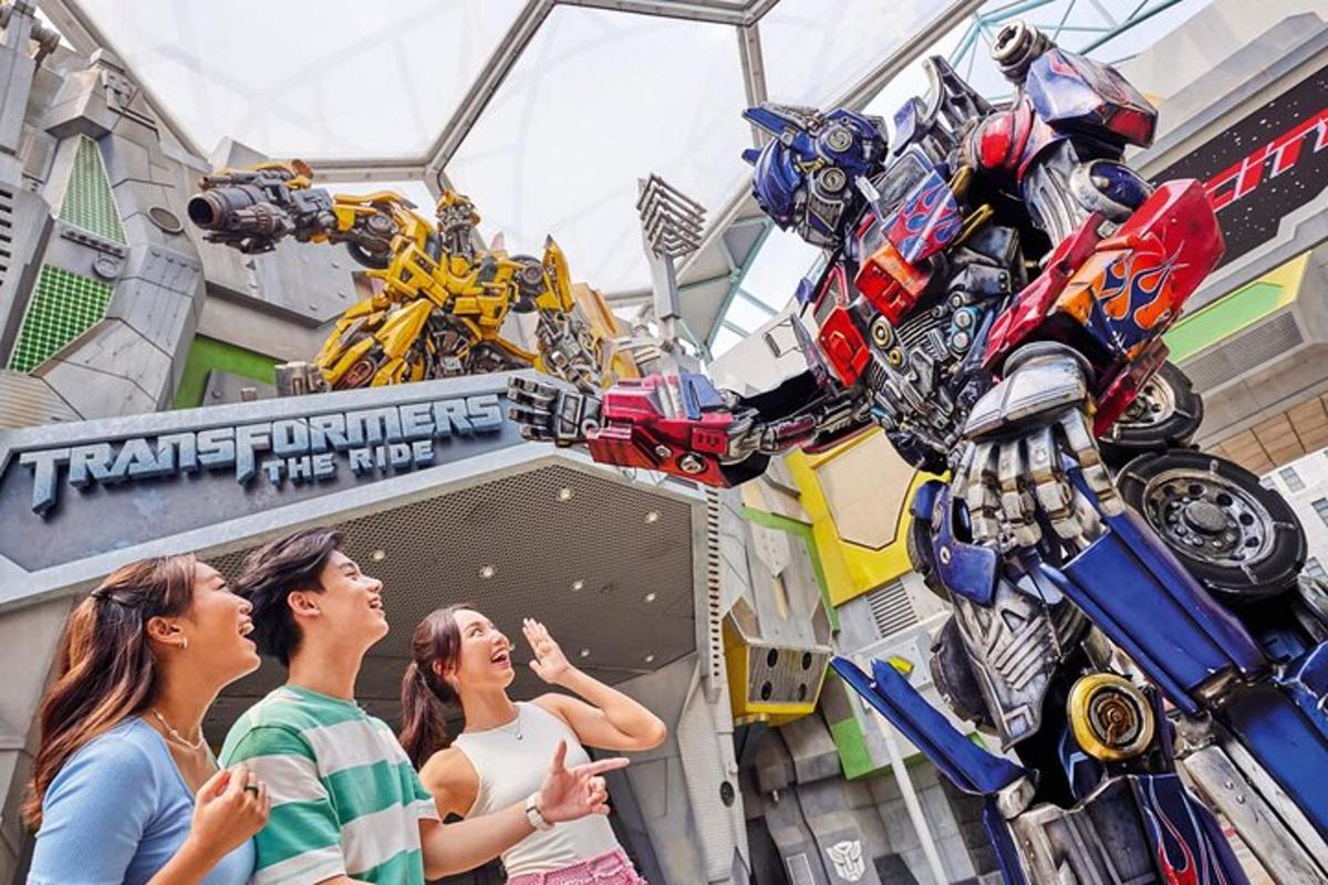 a group of people standing in front of a transformers display