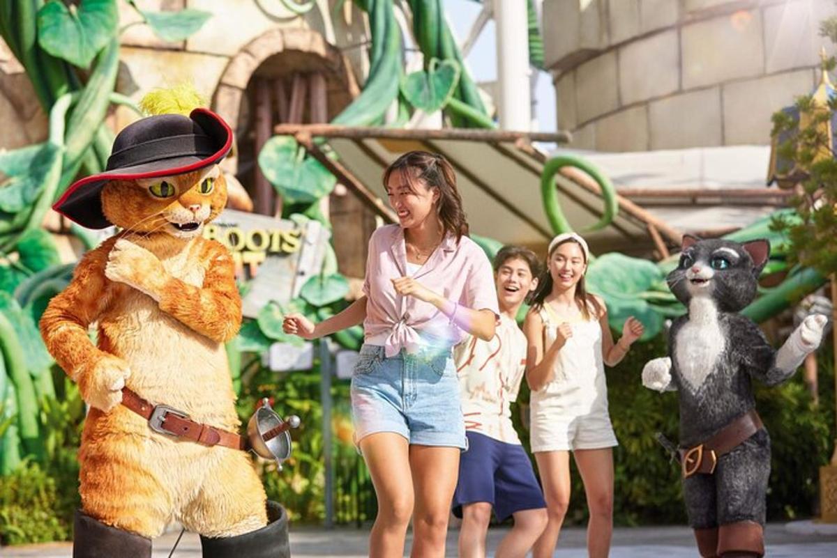 a young girl standing next to a woman in a bear mascot