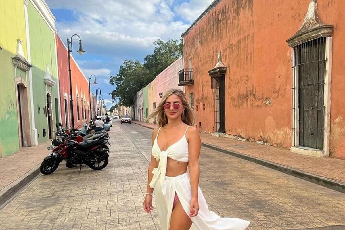 a woman in a white dress walking down a street