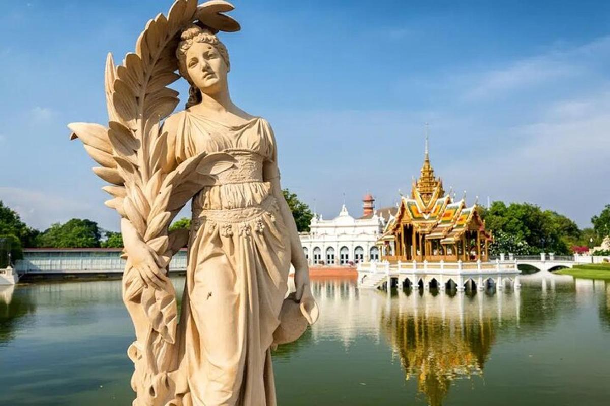 a statue of a woman standing in the water in front of a building