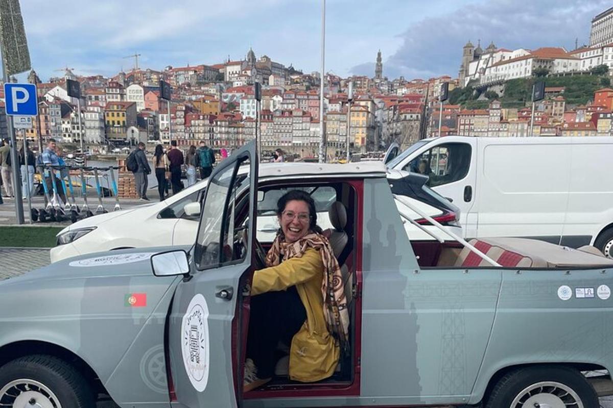 a woman sitting in the back of a small car