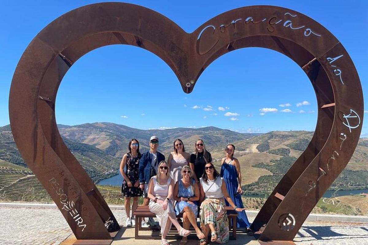 a group of people posing in front of a heart sign