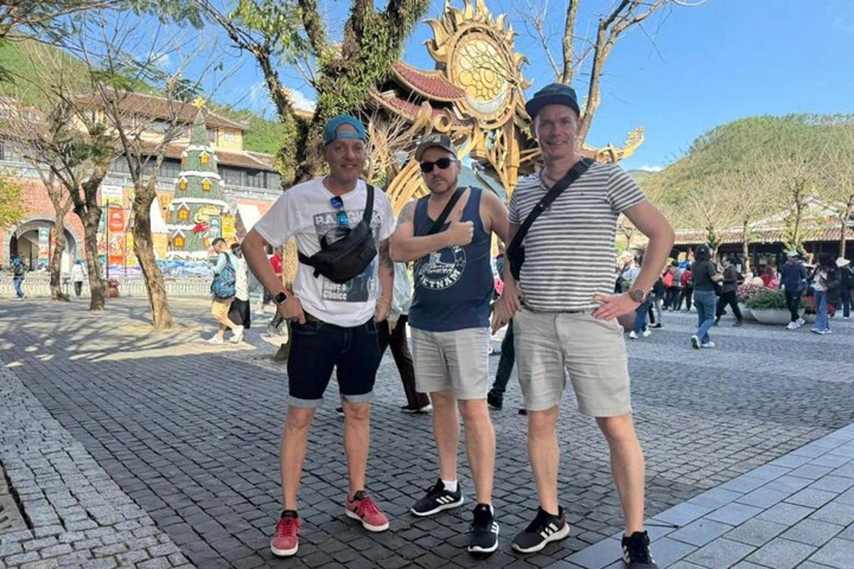 three men posing for a picture in front of a temple