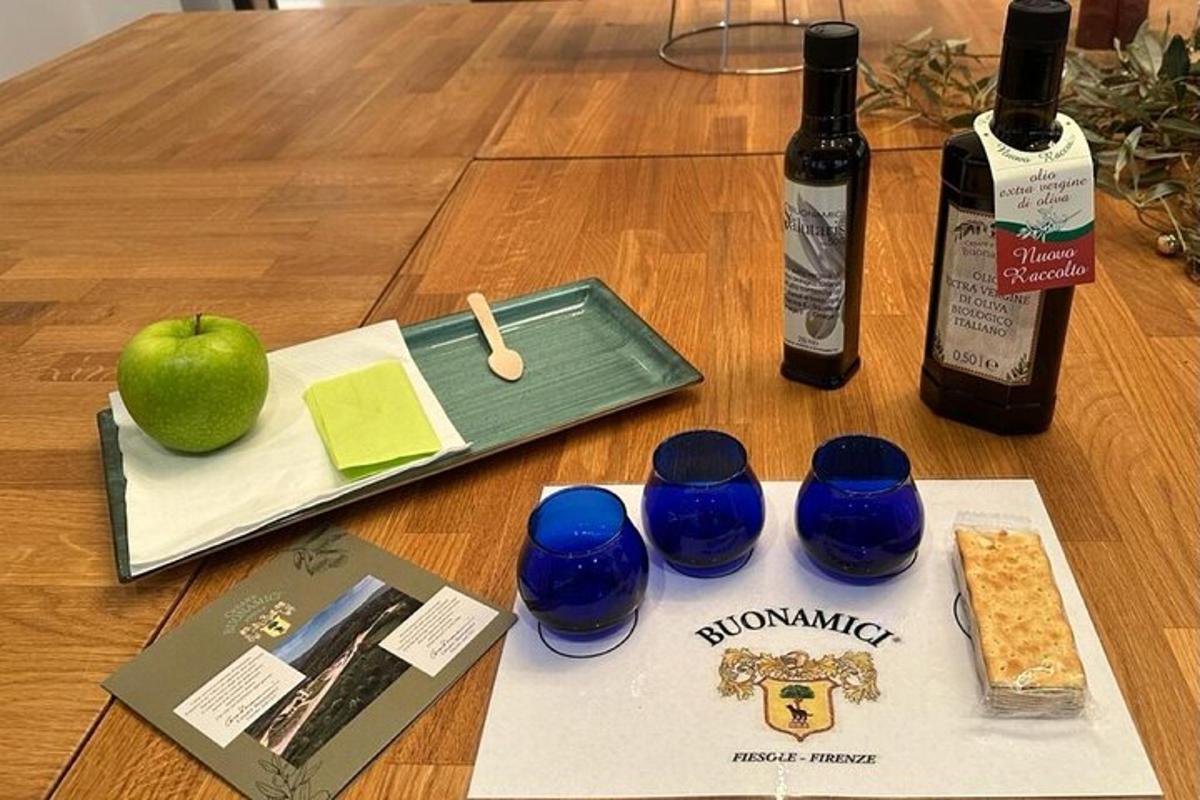 a table with two bottles of wine and three blue glasses