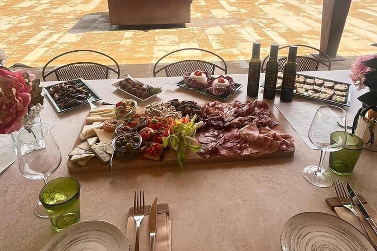 a table with a tray of food and wine bottles