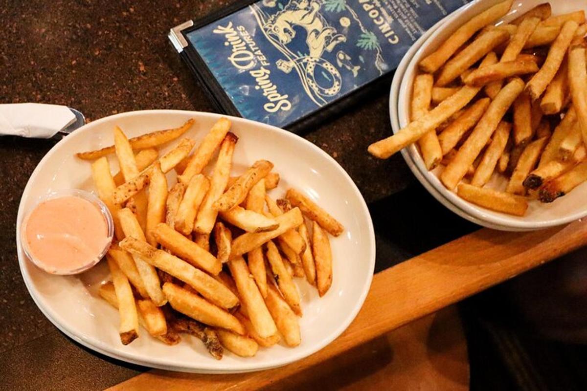 a plate of fries and a bowl of french fries