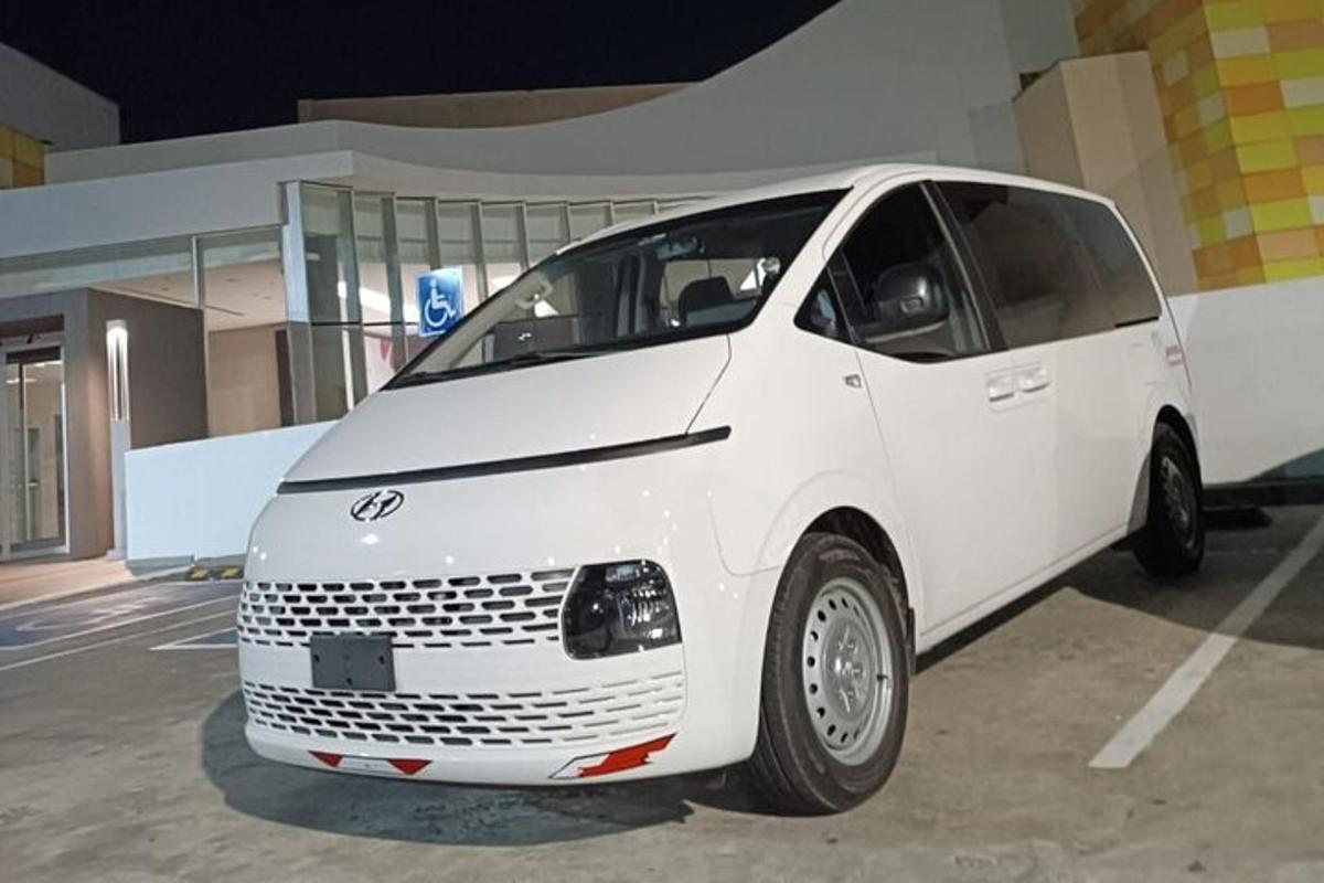 a white van parked in front of a building