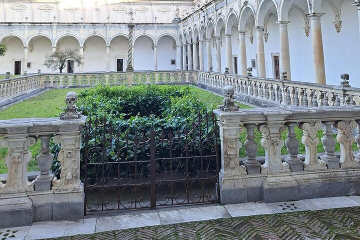 a fence in front of a building with a garden