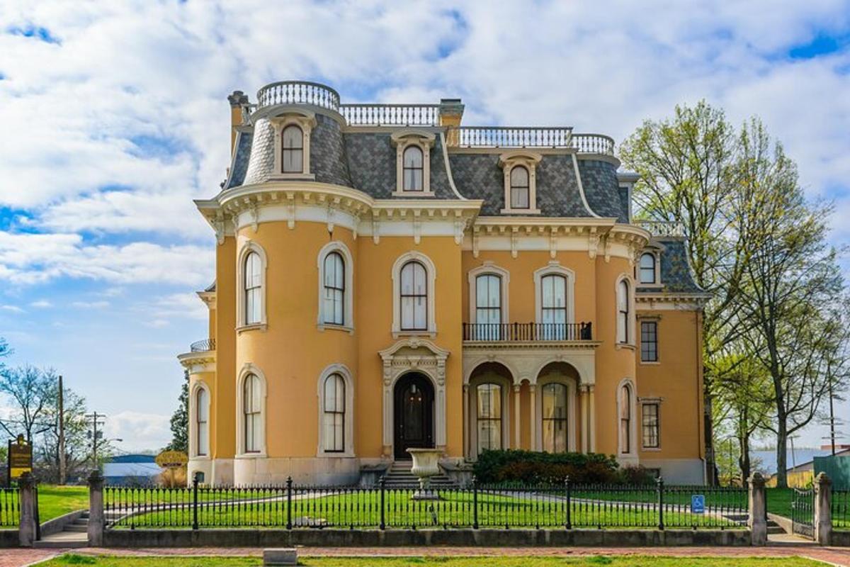 a large yellow house with a gray roof