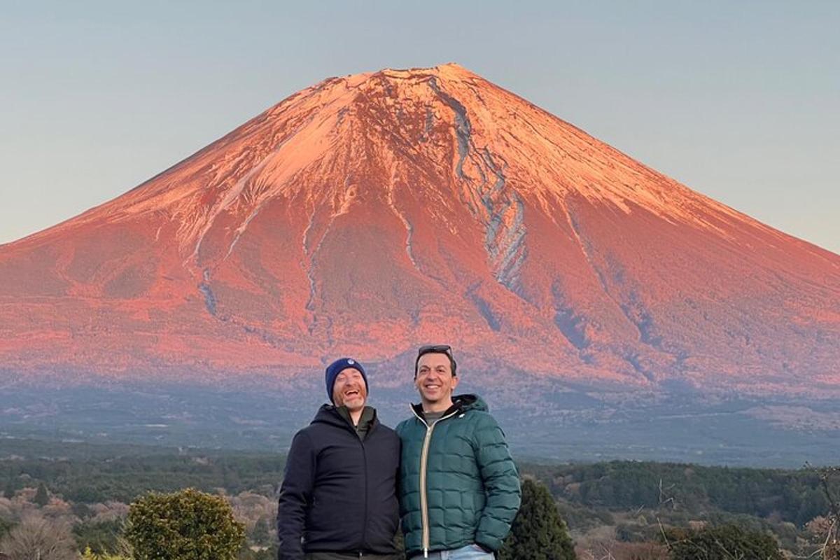 a man and woman standing in front of a mountain