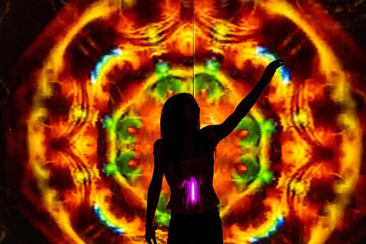 a woman holding an umbrella in front of a fireball