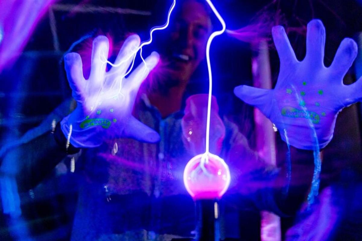 a person with their hands in the air with a light