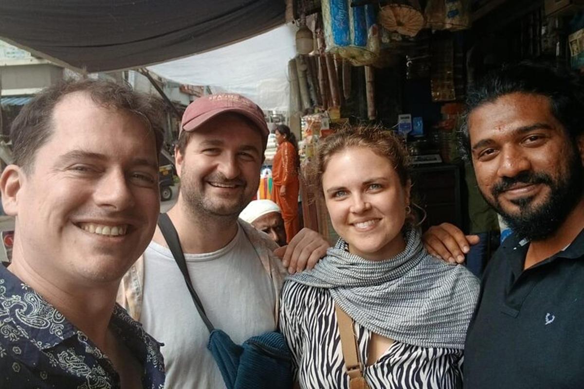 three men and a woman posing for a picture