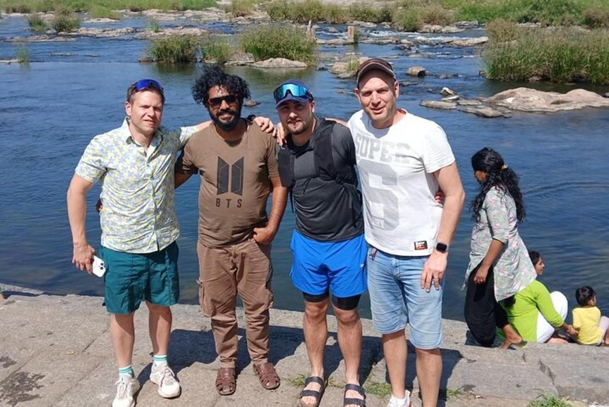 a group of men standing next to a river