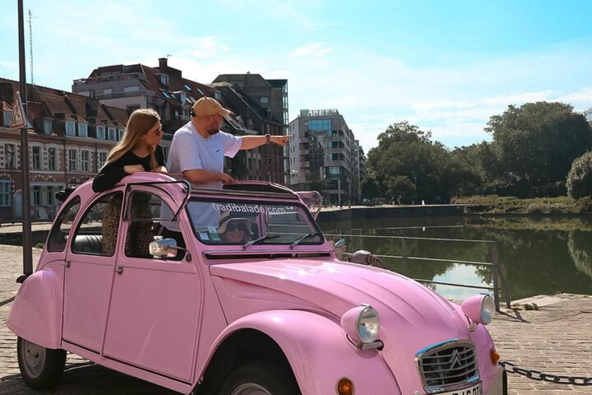 a man and a woman sitting in a pink car
