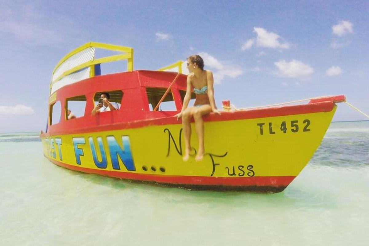 a woman sitting on a boat on the beach