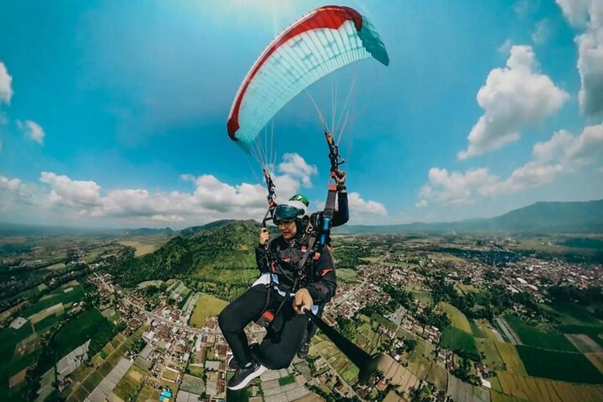 a man flying with a parachute in the air