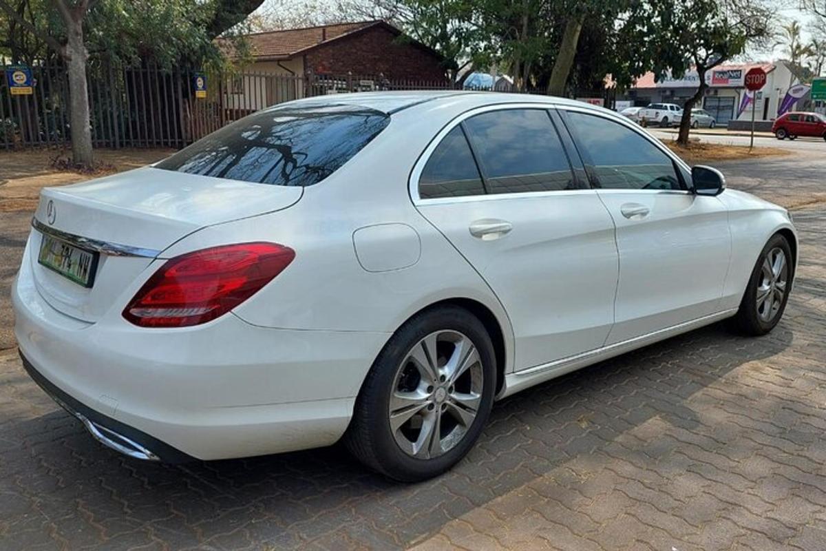 a white car parked on a brick street