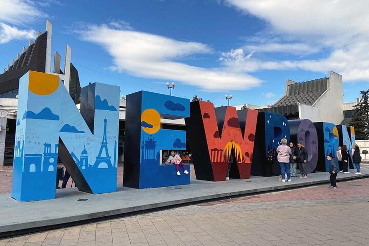 a large sign that says art on a sidewalk