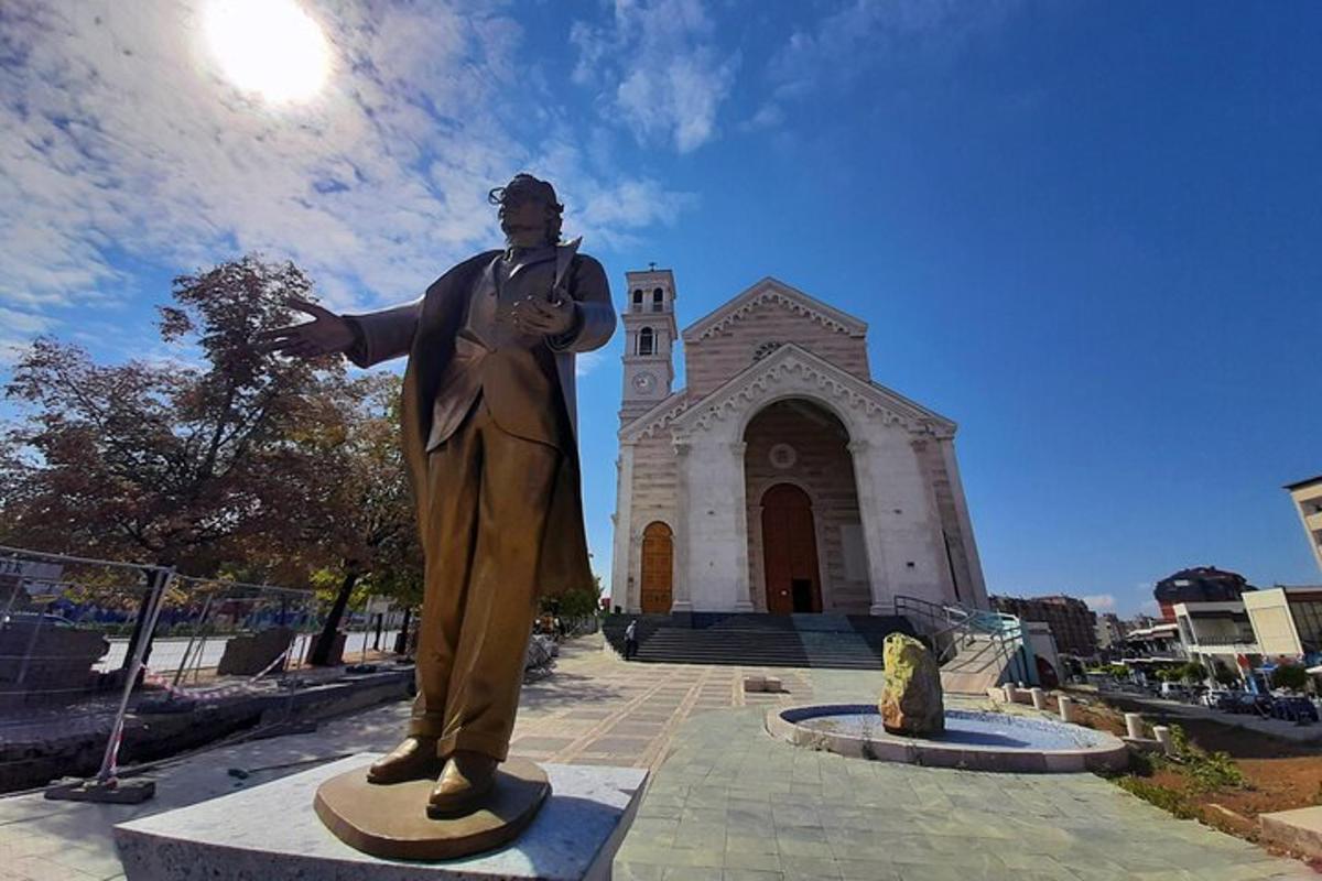 a statue of a man standing in front of a building