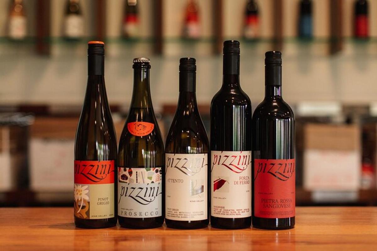 a group of four bottles of wine sitting on a table
