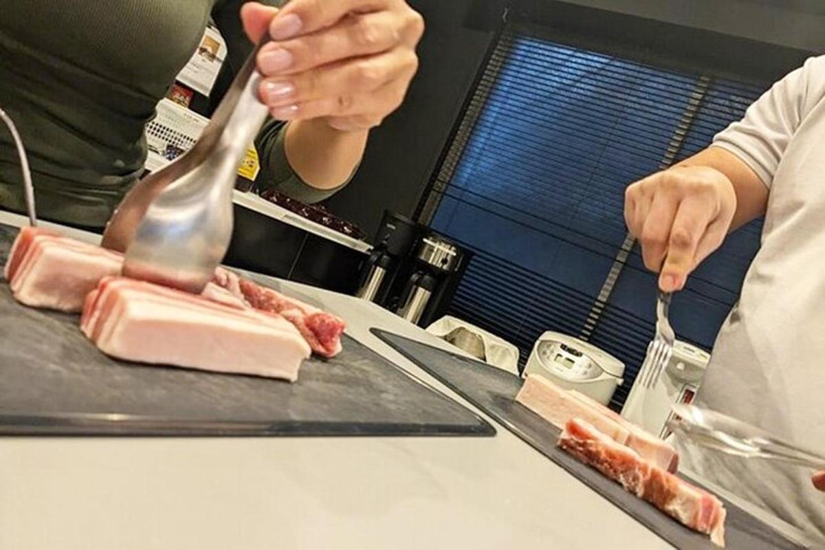 a person preparing meat on a counter with a spoon
