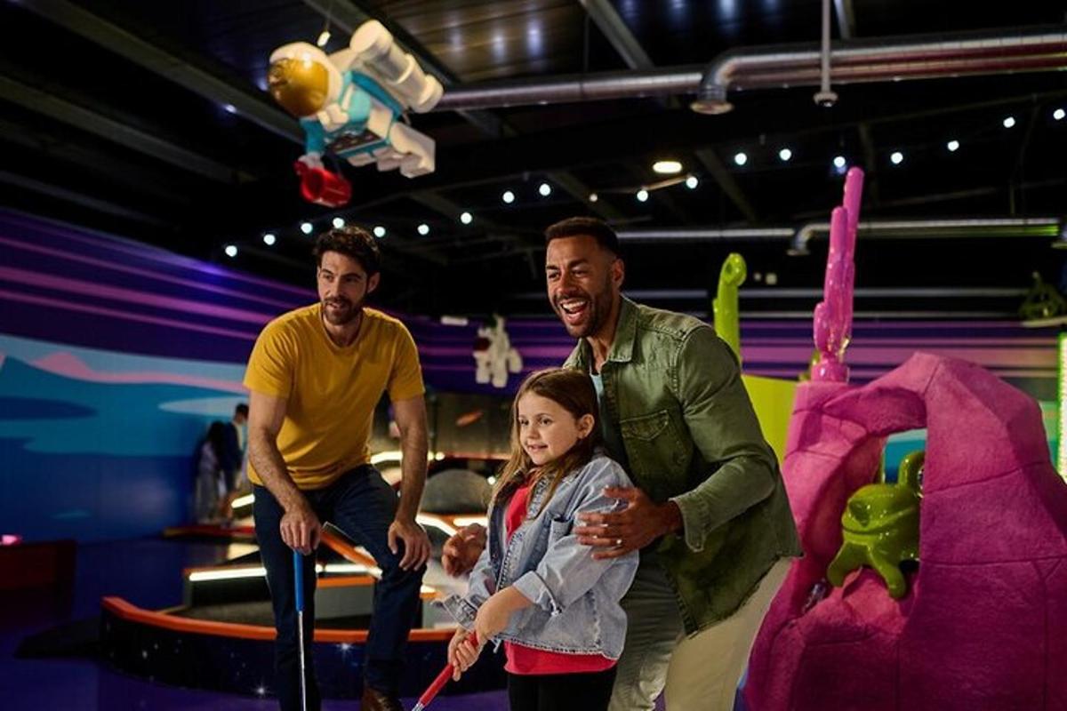 two men and a girl playing a game on a wii