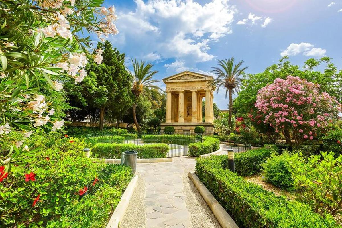 a garden with a building and some flowers and trees