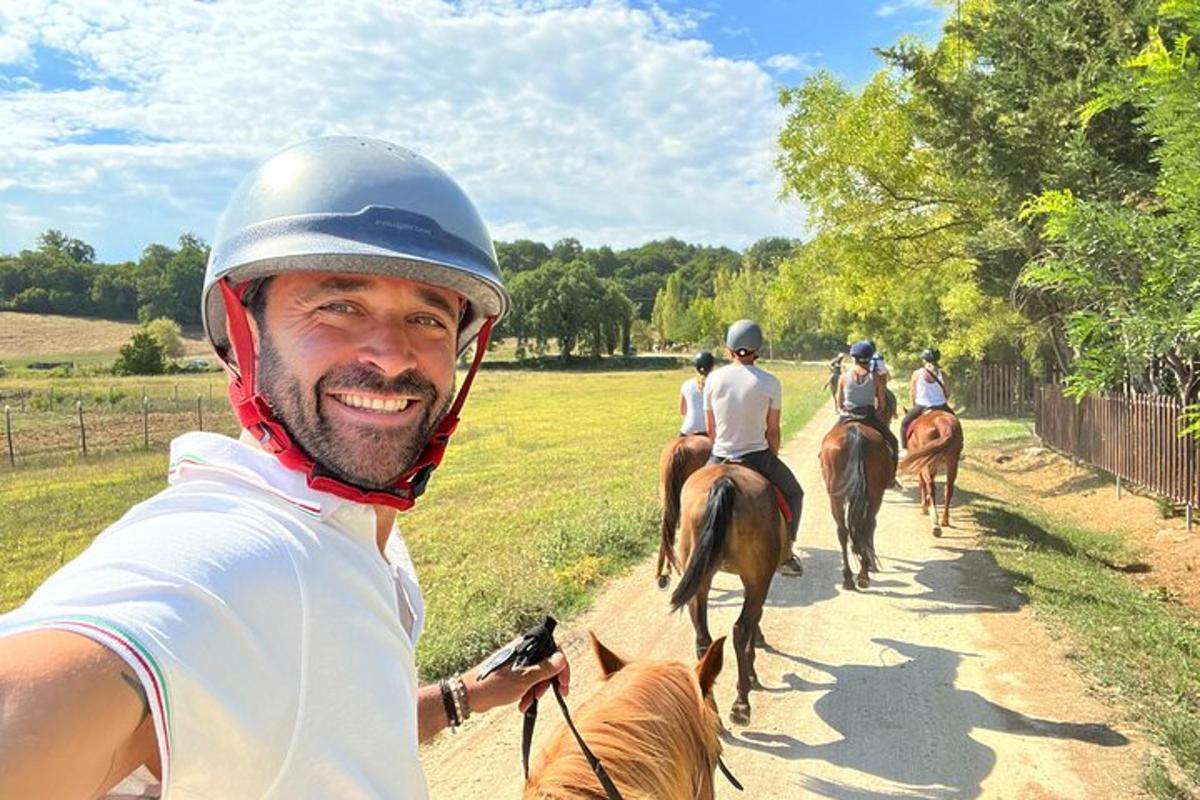 a group of people riding horses down a dirt road