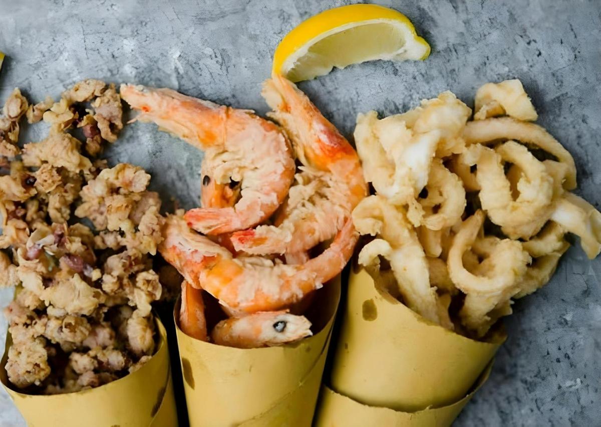 a bunch of food with shrimp and a lemon slice