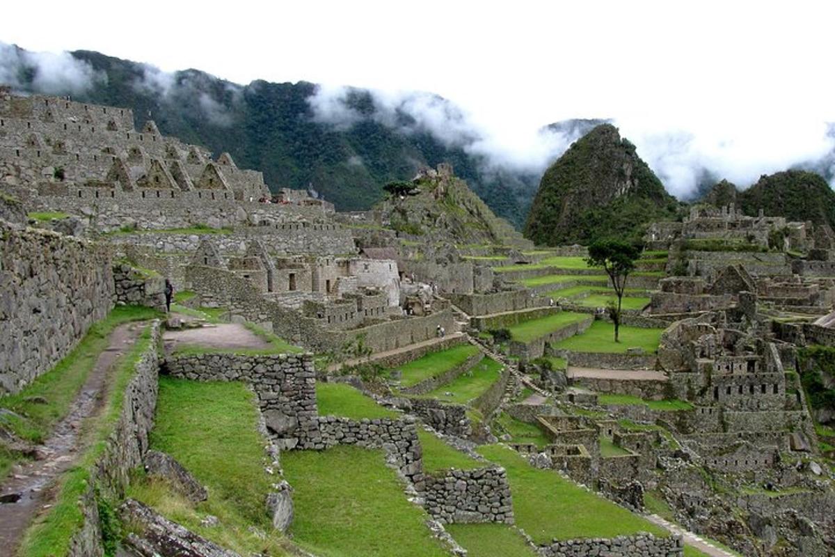 a view of an ancient ruins with mountains in the background