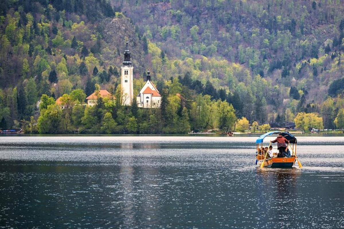 a small boat in a lake with a castle in the distance