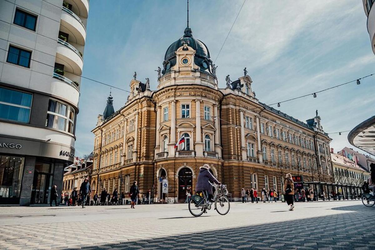 a person riding a bike in front of a building