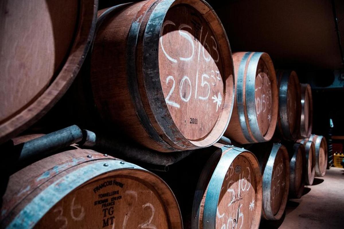 a bunch of wooden barrels lined up in a row