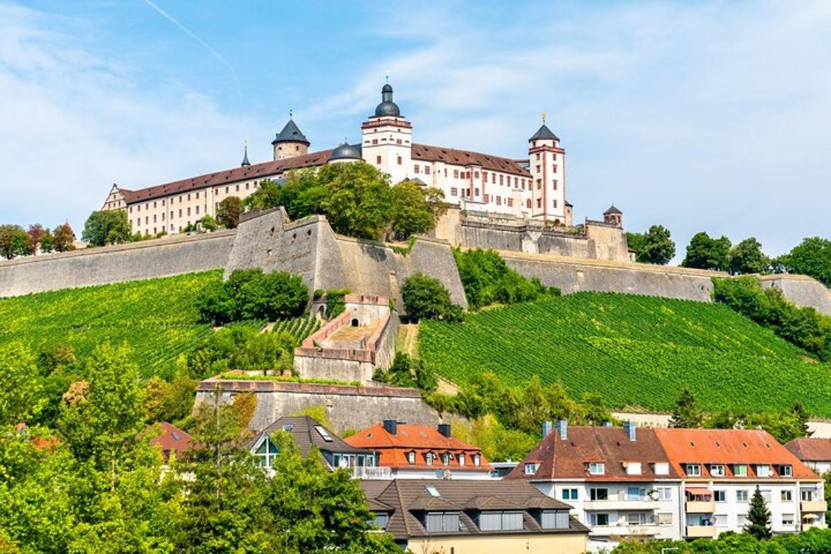 a large castle on top of a hill with houses