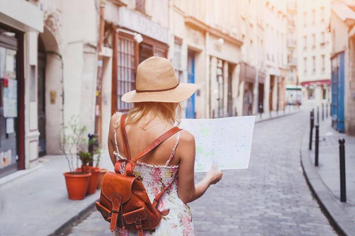 a woman in a hat is walking down a street