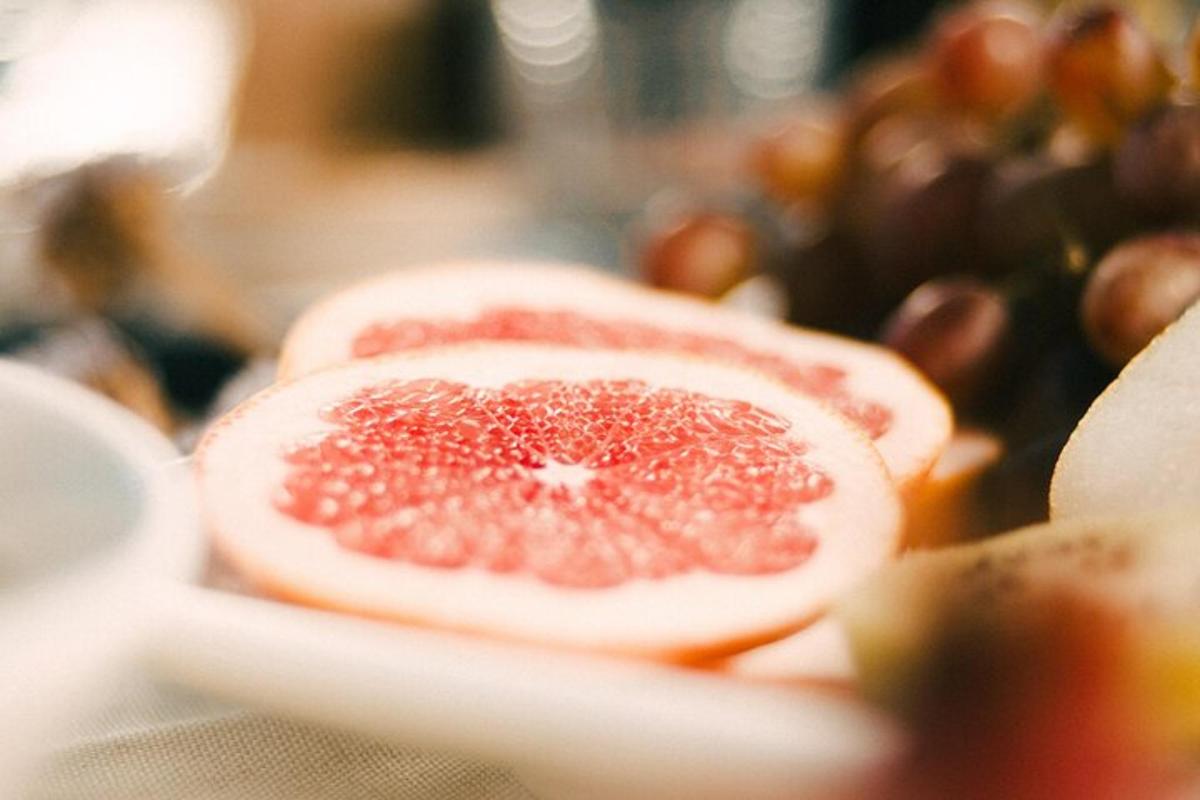 a grapefruit cut in half sitting on a plate