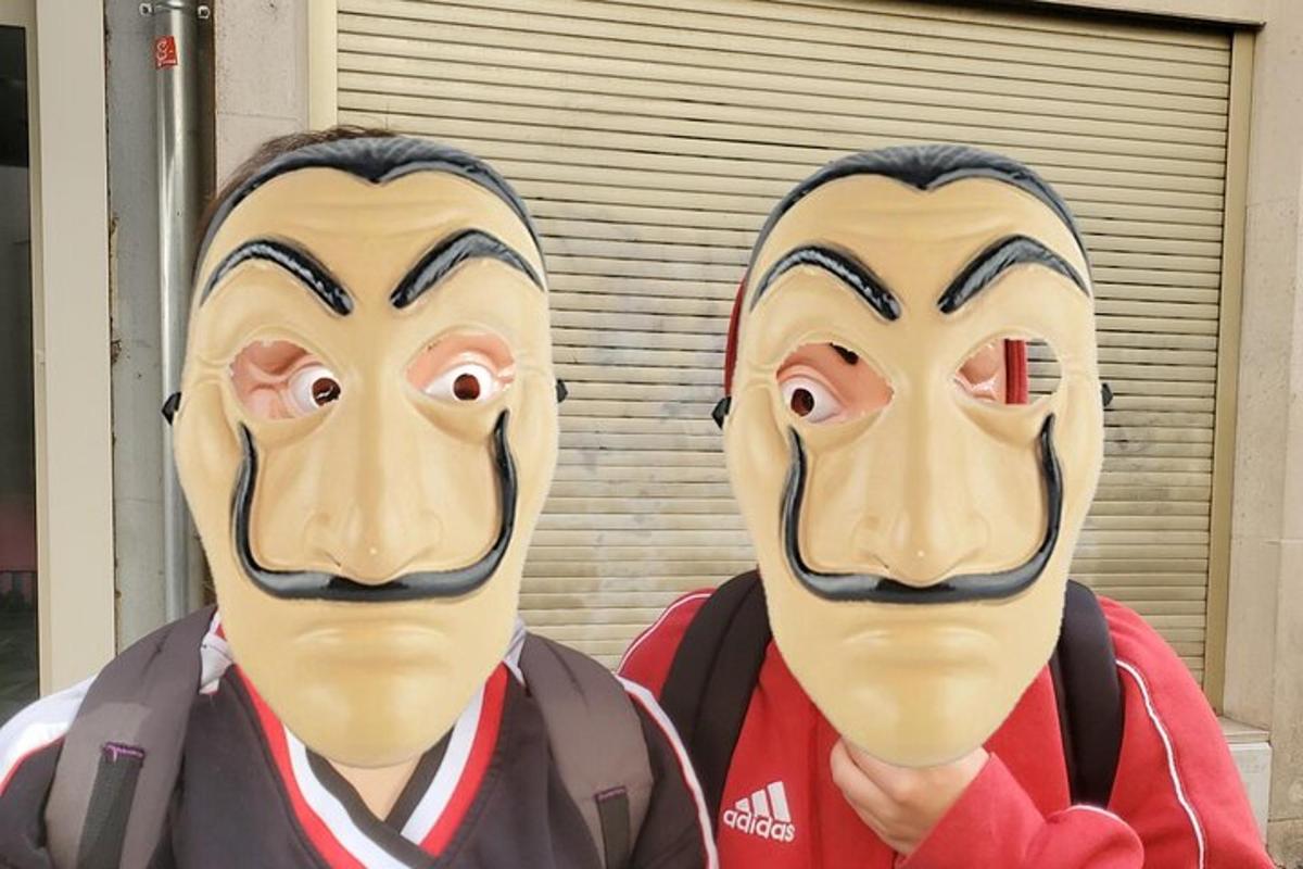two statues of two people wearing masks