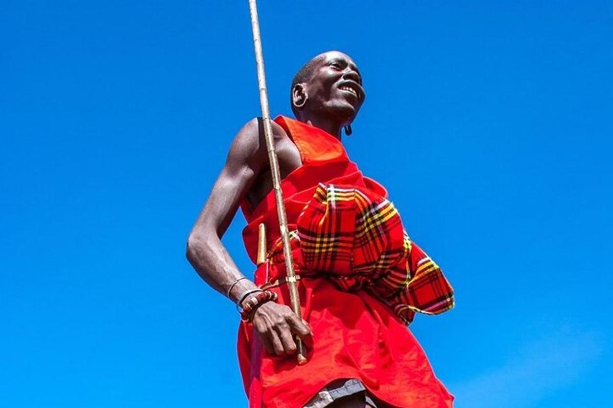 a man in a red dress holding a spear