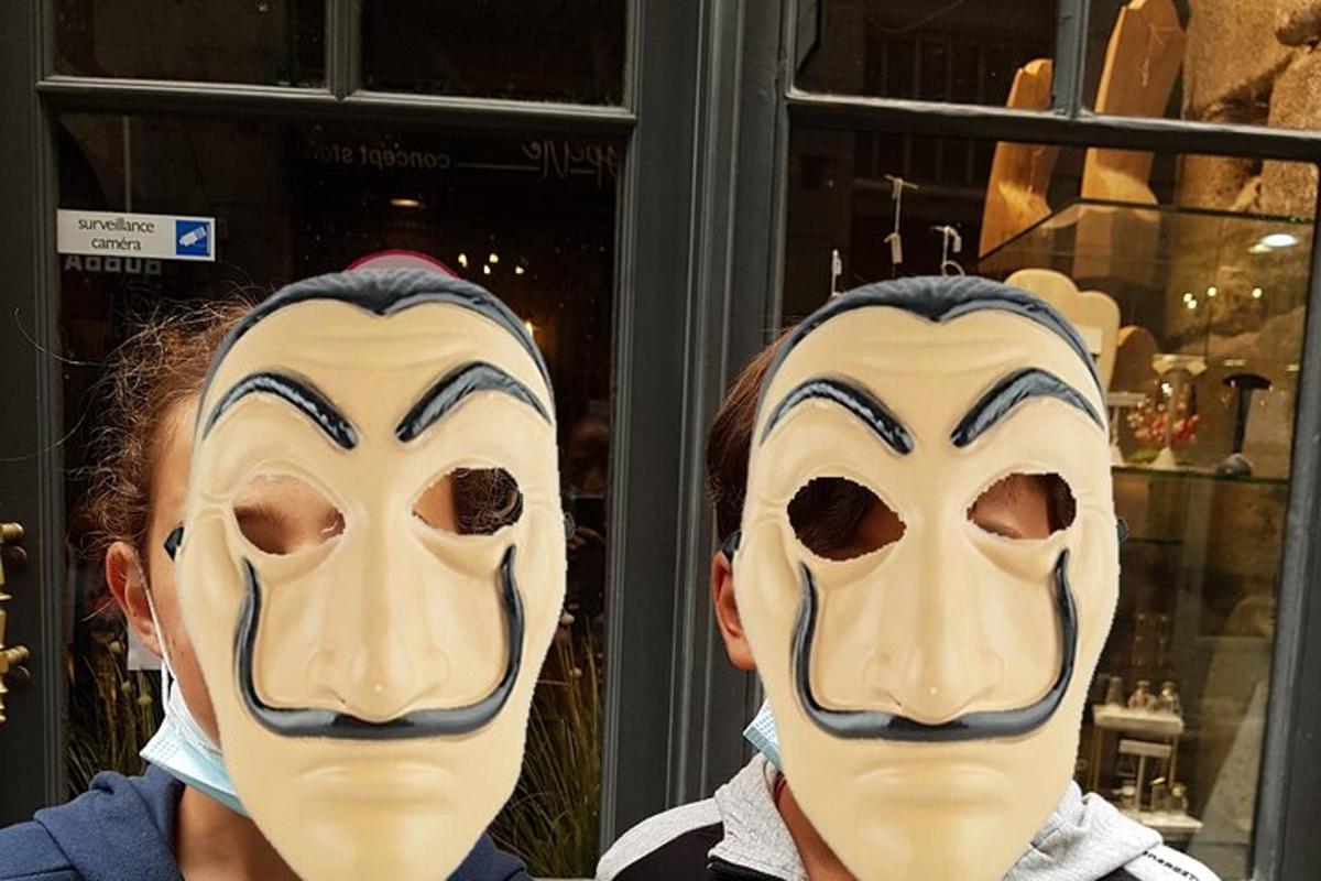 two people with masks on their faces in front of a store