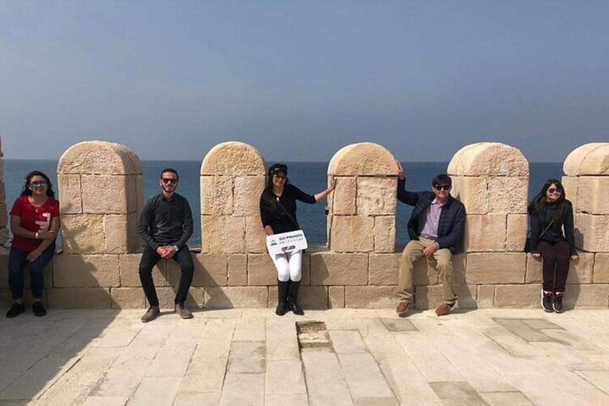 un gruppo di persone sedute su un muro