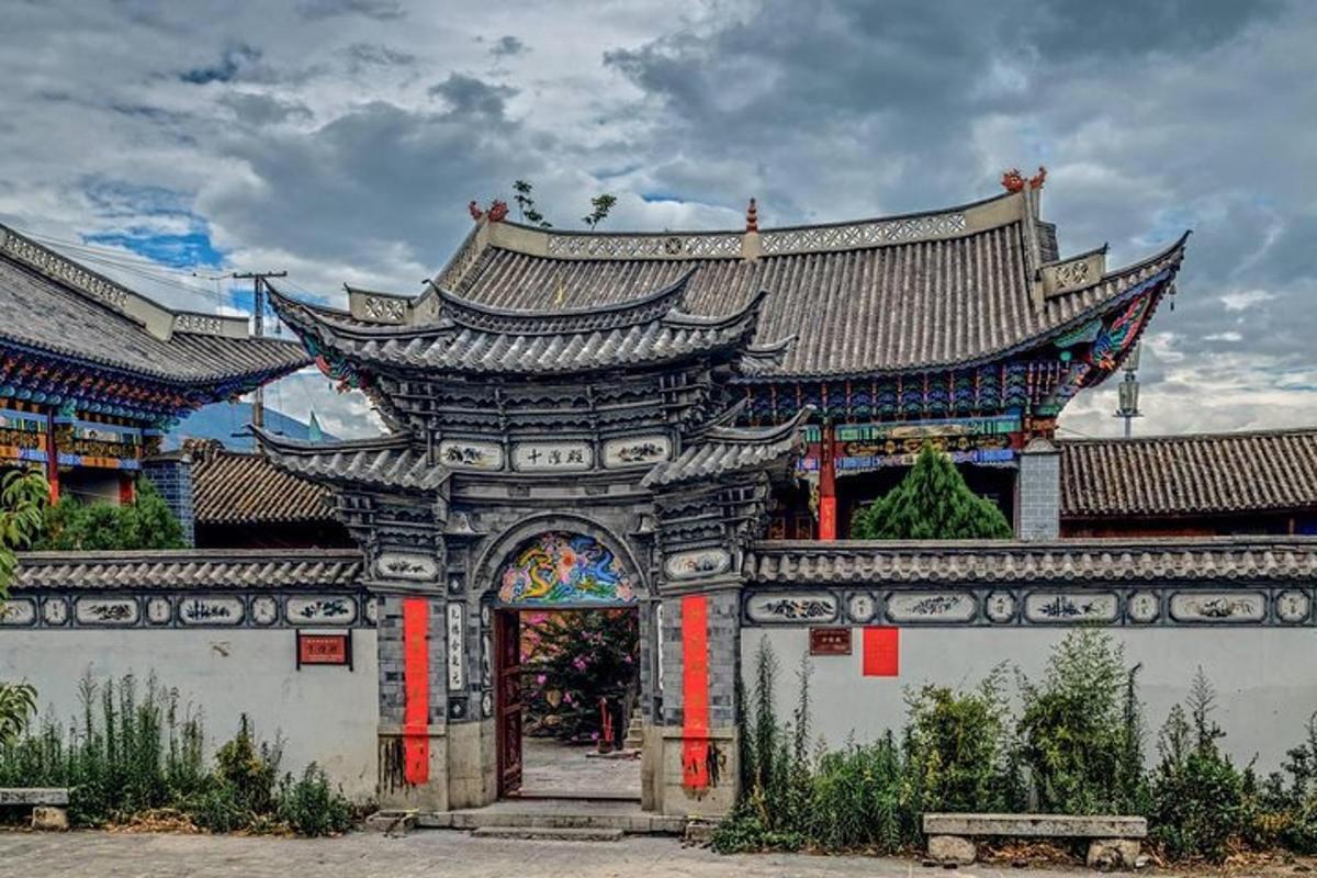 a large building with an arch in front of it
