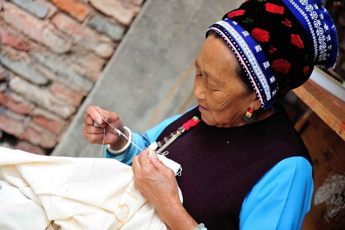 an older woman wearing a headdress holding a string