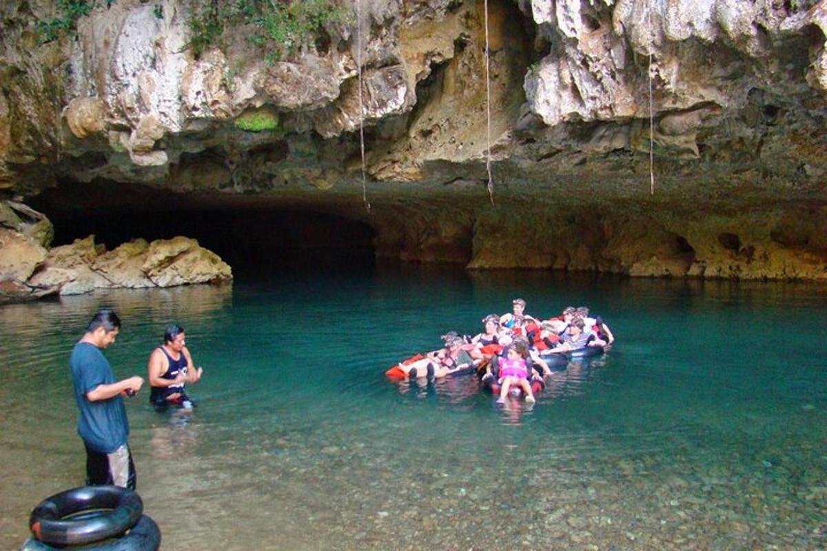 a group of people in the water in a cave